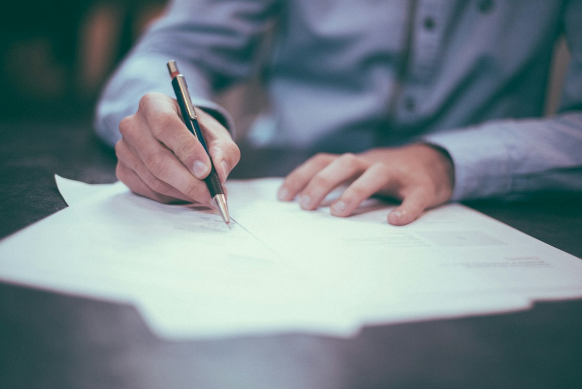 Hands reviewing planning documents at a desk